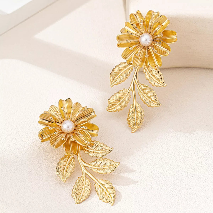 Golden 18K gold-plated floral drop earrings with pearl accents and leaf details.