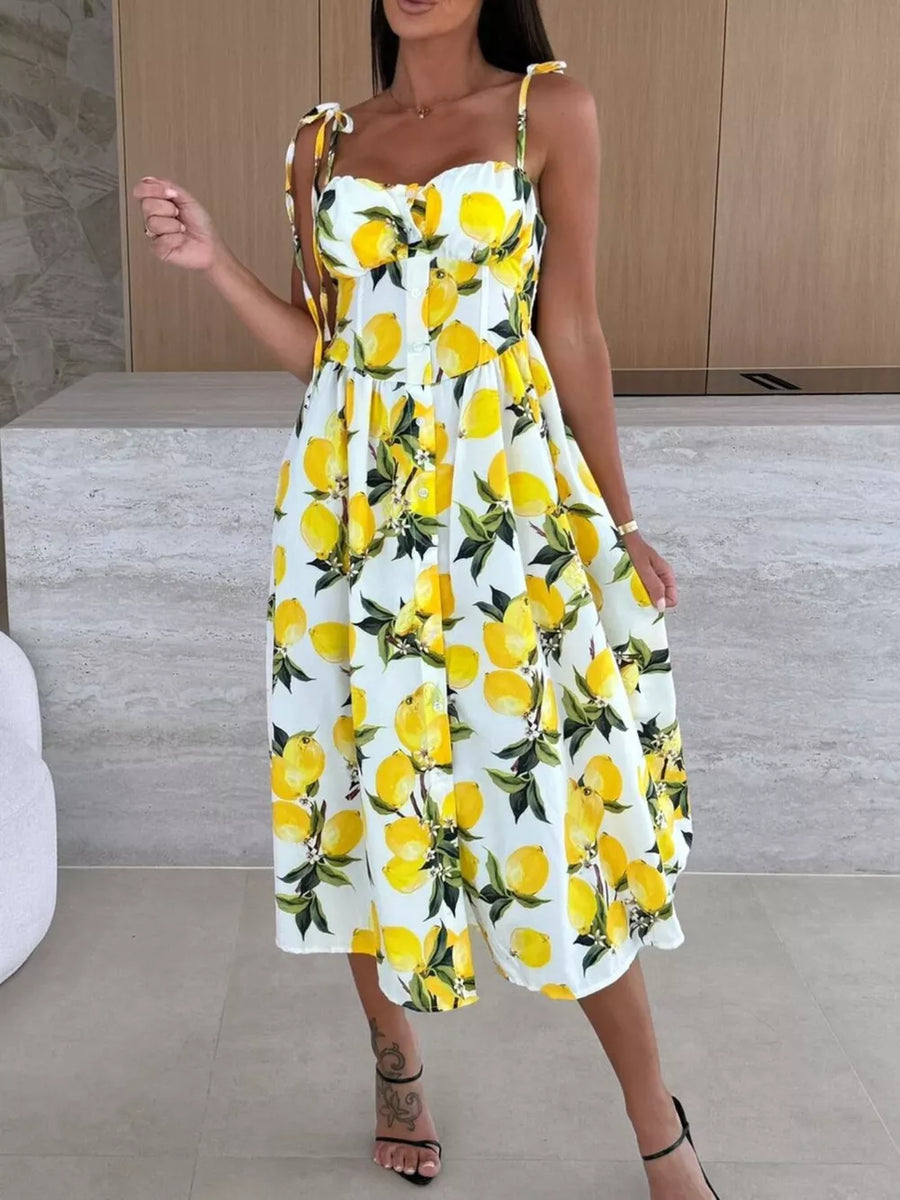 Floral tie-strap midi dress with a lemon print and button front.
