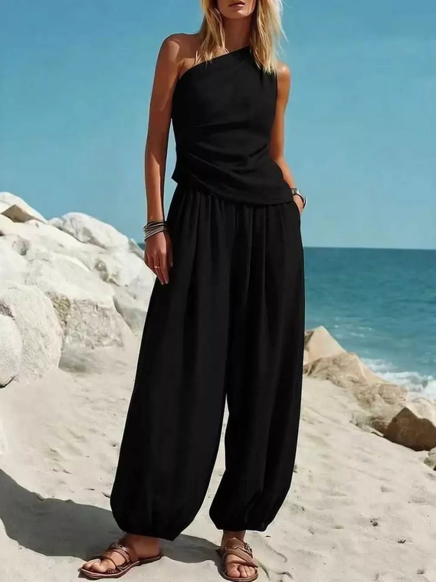 Black one-shoulder jumpsuit with wide-leg pants and ruched detailing