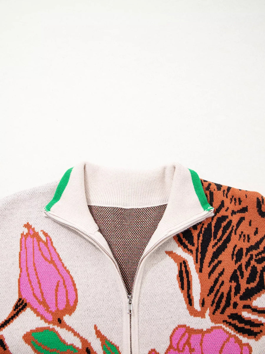 Knit quarter zip sweater with floral and tiger print, stand neck, and green collar trim.
