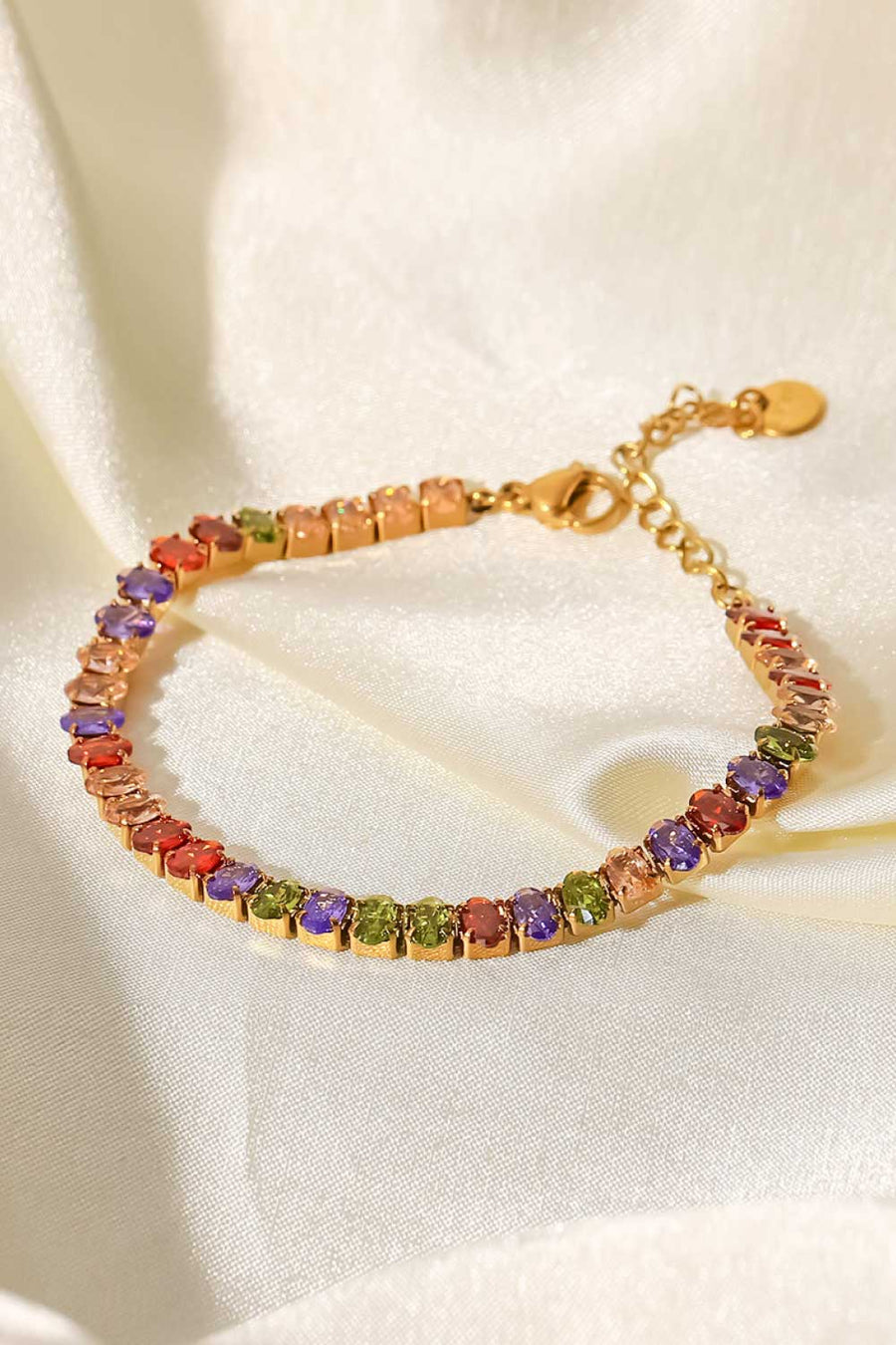 18K gold plated tennis bracelet with multi-colored cubic zirconia stones.