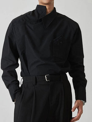 Black architectural collar asymmetric button-up shirt with a chest pocket and button details.