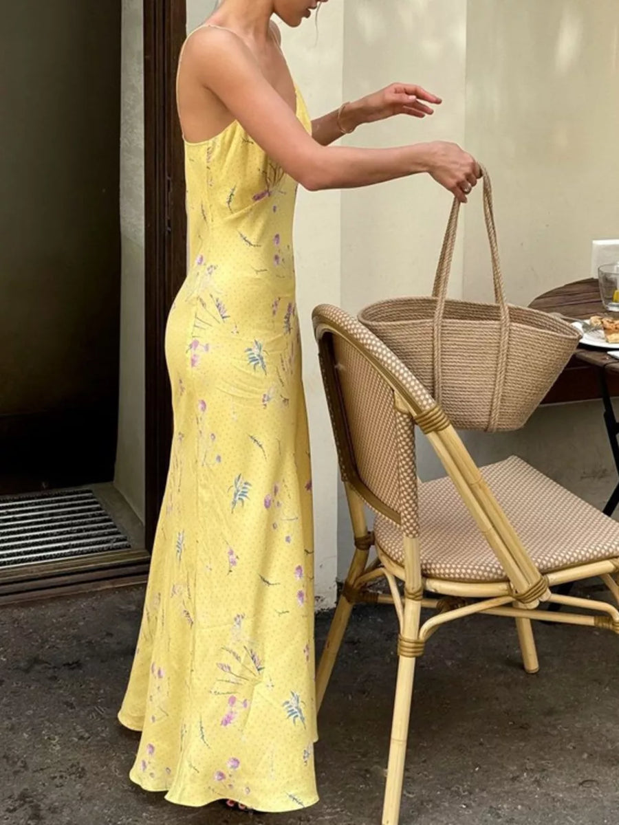 Yellow floral print slip dress with spaghetti straps and a maxi length.