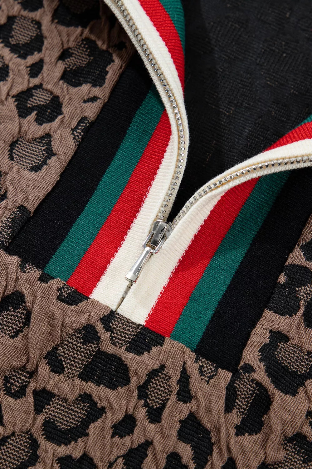 Brown leopard jacquard half-zip shirt with red, green, and black striped trim.