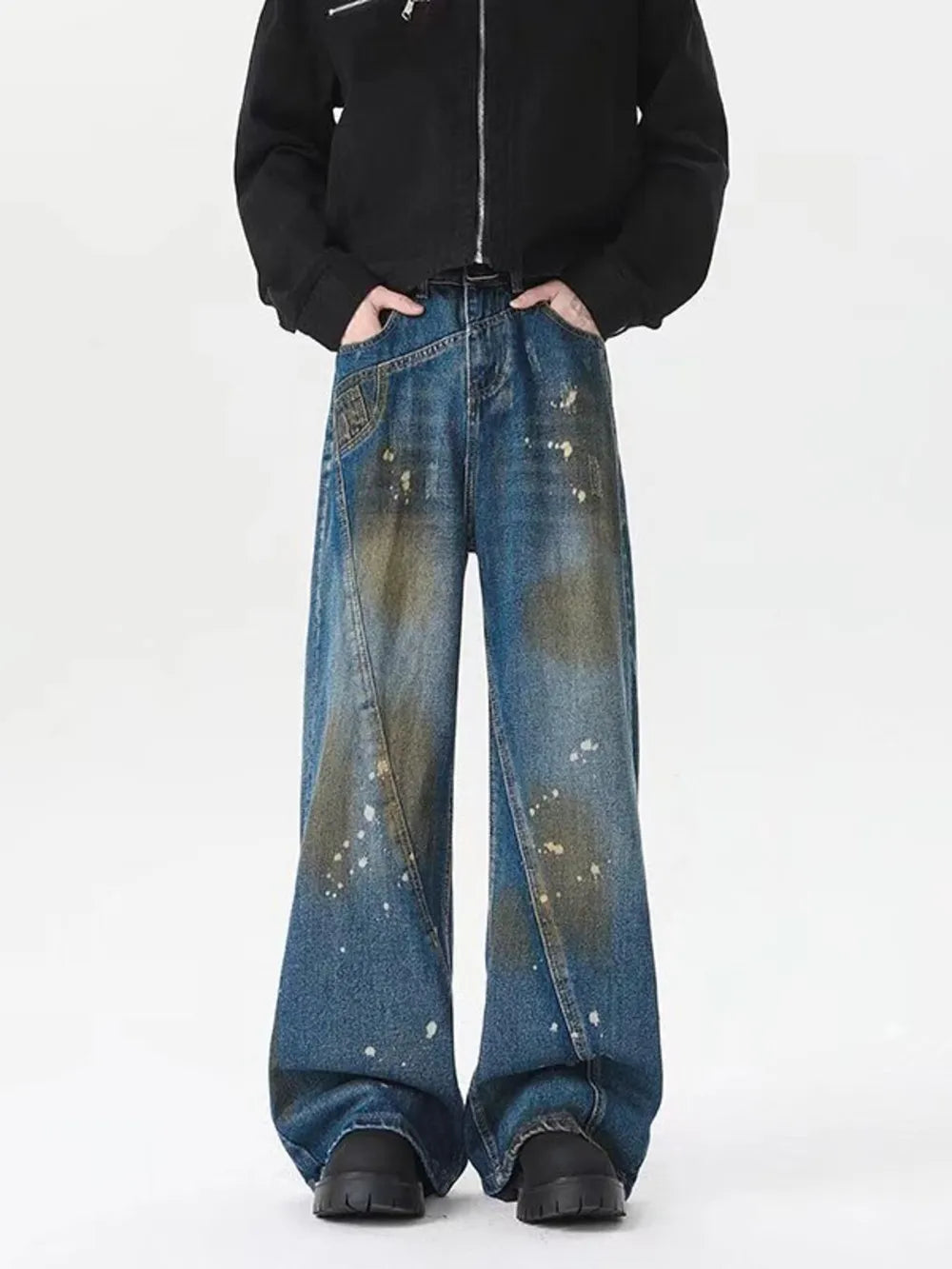 Men's plus-size wide-leg jeans in washed blue denim with paint splatter details.
