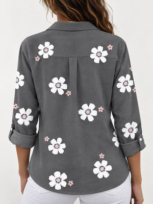 white button-down shirt featuring buttoned and floral
