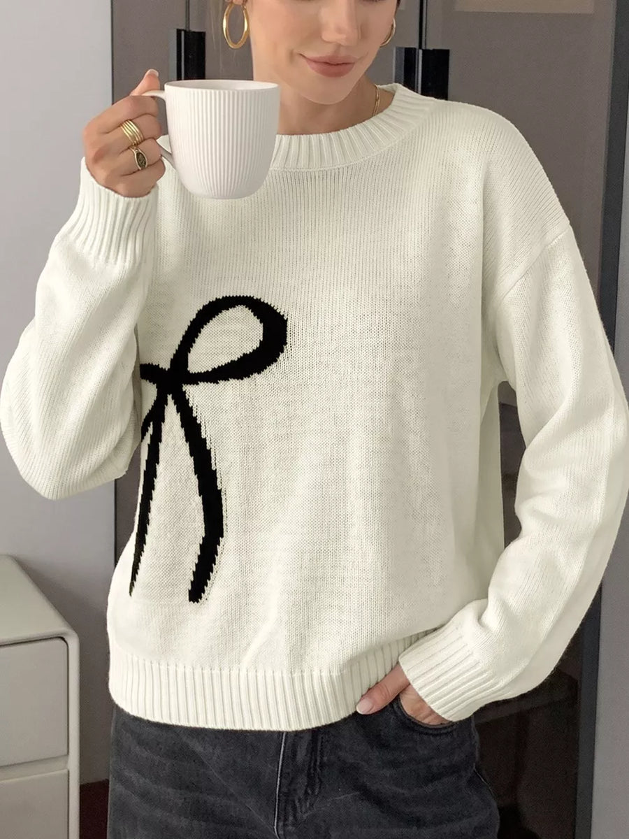 Cream knit crewneck sweater with black bow graphic and ribbed trim