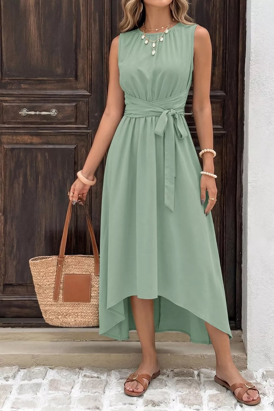 Sage green sleeveless high-low a-line dress with ruched waist tie and round neckline