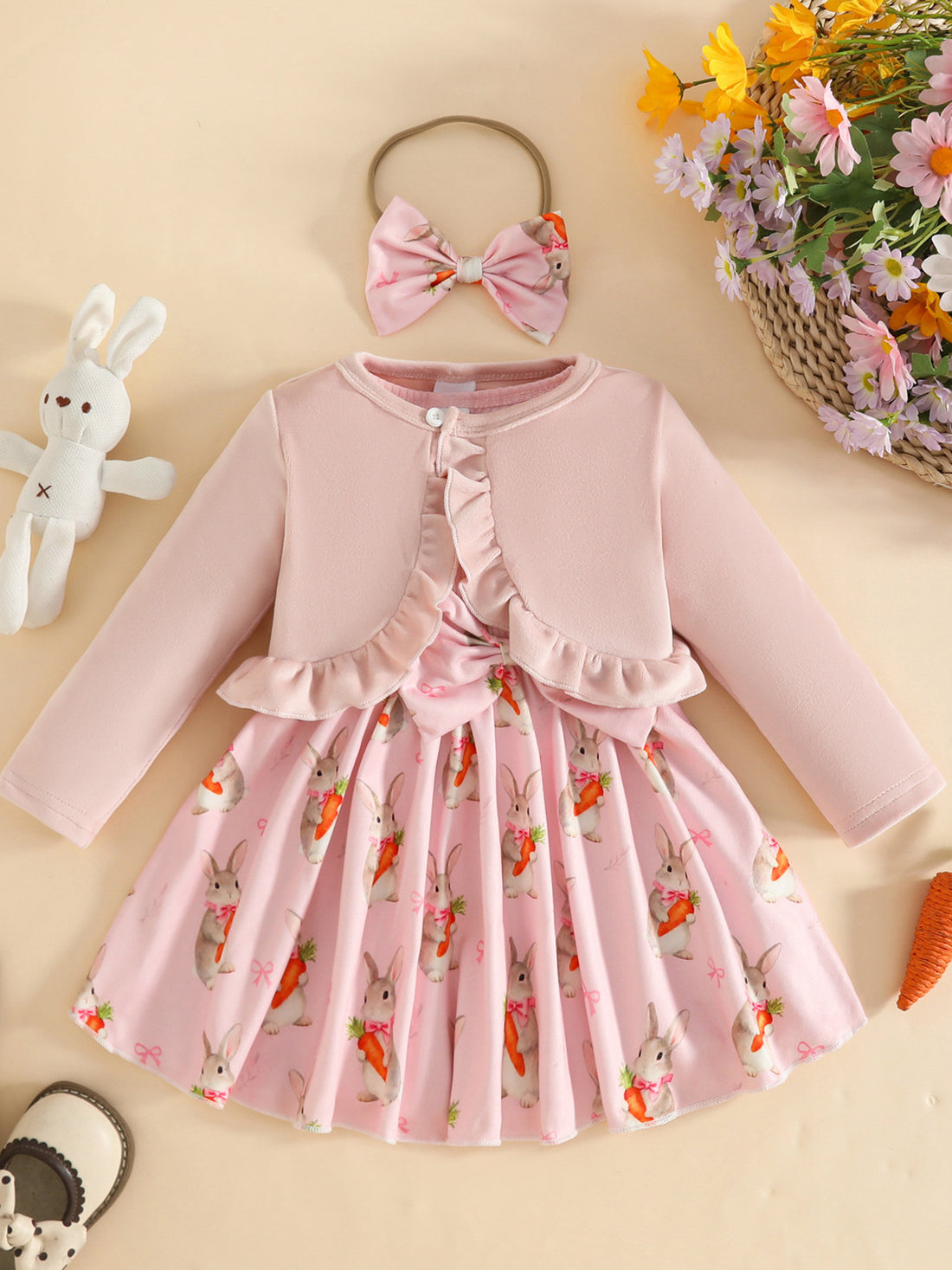 Pink baby set with ruffled cardigan and bunny carrot print dress, includes matching bow headband.