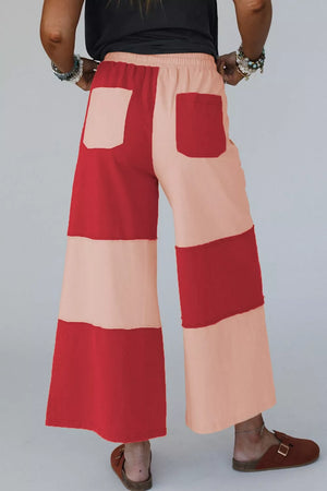 blush pink wide-leg pants featuring drawstring waist and color-block