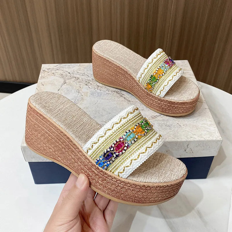 Embroidered platform wedge slides with colorful bead detail and woven wedge heel.