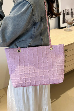 Textured bouclé shoulder bag in pink with a chain strap.