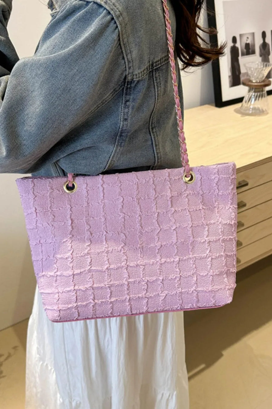 Textured bouclé shoulder bag in pink with a chain strap.