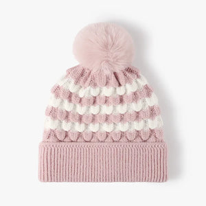 Blush pink and white scalloped stripe knit beanie with a pink pompom.