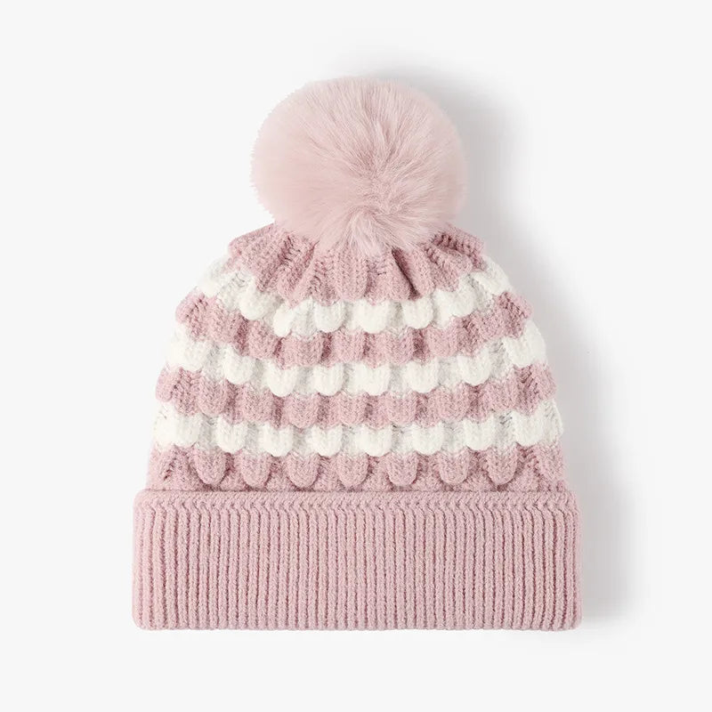 Blush pink and white scalloped stripe knit beanie with a pink pompom.