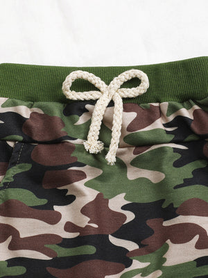 Baby camo shorts with green waistband and cream drawstring.