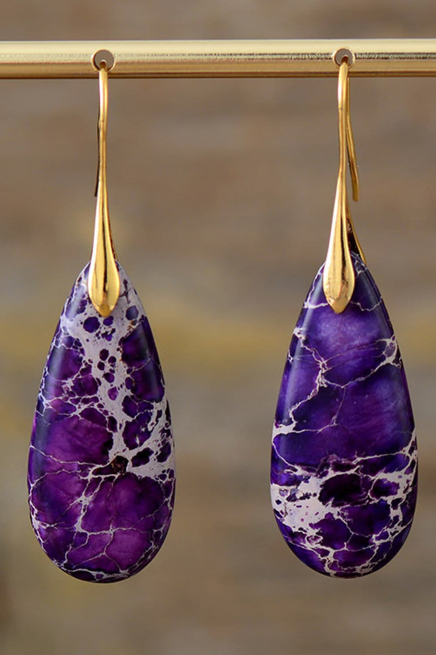 Purple and gold dangle earrings with teardrop-shaped ocean jasper stones.