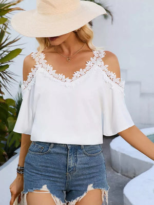 White cold shoulder maternity shirt with lace trim and flutter sleeves.