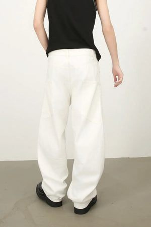 White wide leg trousers with sculpted pocket details and a relaxed fit.