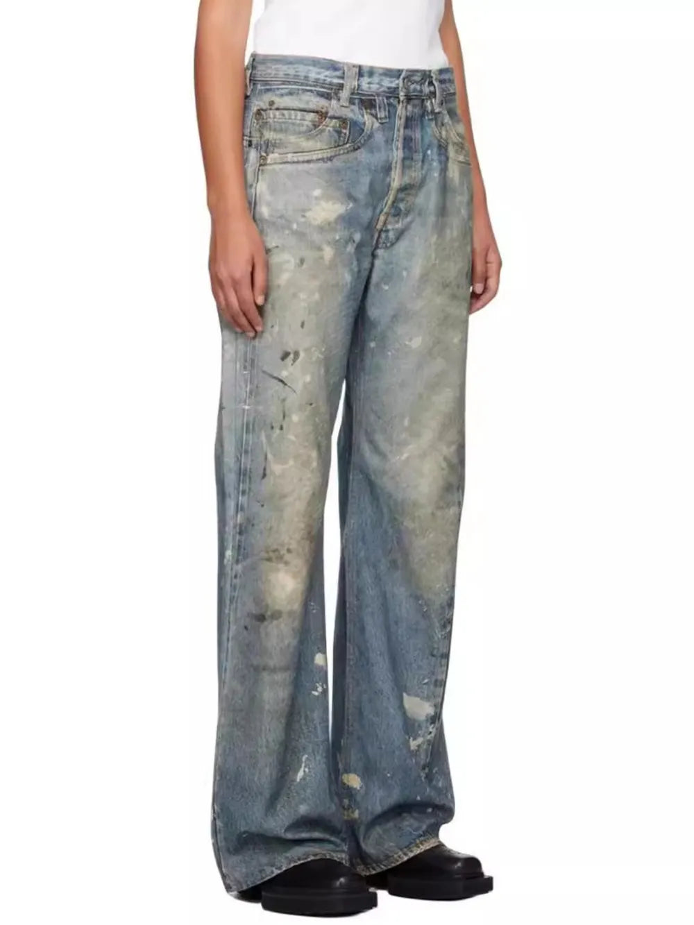Distressed wide-leg jeans in medium wash denim with painterly splatters and a relaxed fit.