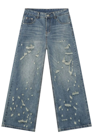 Distressed palazzo denim jeans in medium wash with raw edge detail and ripped accents.