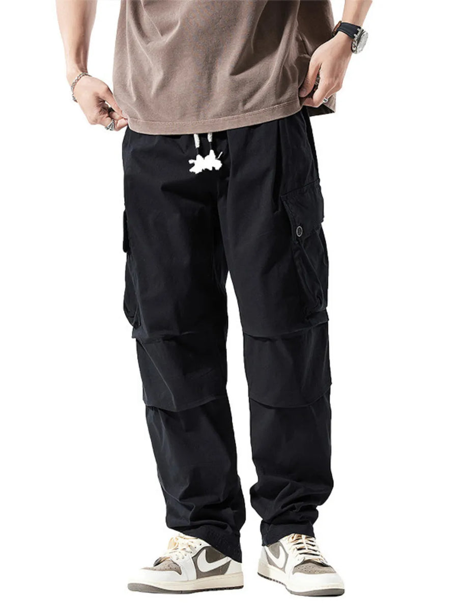 Men's black cargo sweatpants with drawstring and multiple pockets.