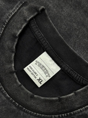 Black acid wash oversized tee with distressed neckline and size XL tag.