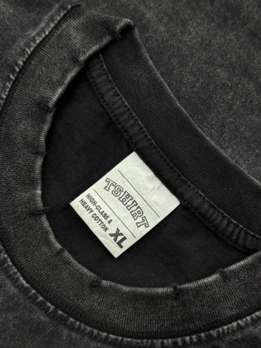 Black acid wash oversized tee with distressed neckline and size XL tag.