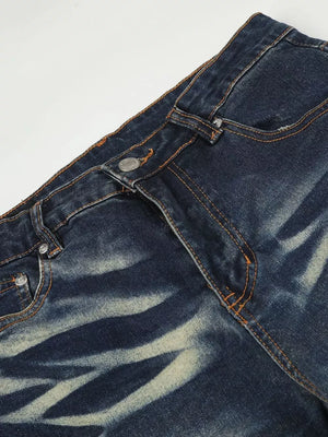 Distressed dark wash flare jeans with button fly and pocket details.