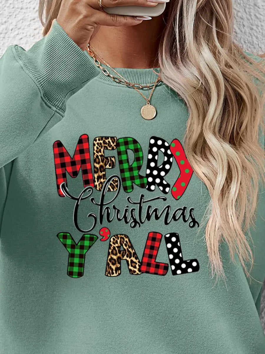Sage green sweatshirt with Merry Christmas Y'all graphic in mixed prints: plaid, leopard, polka dot.