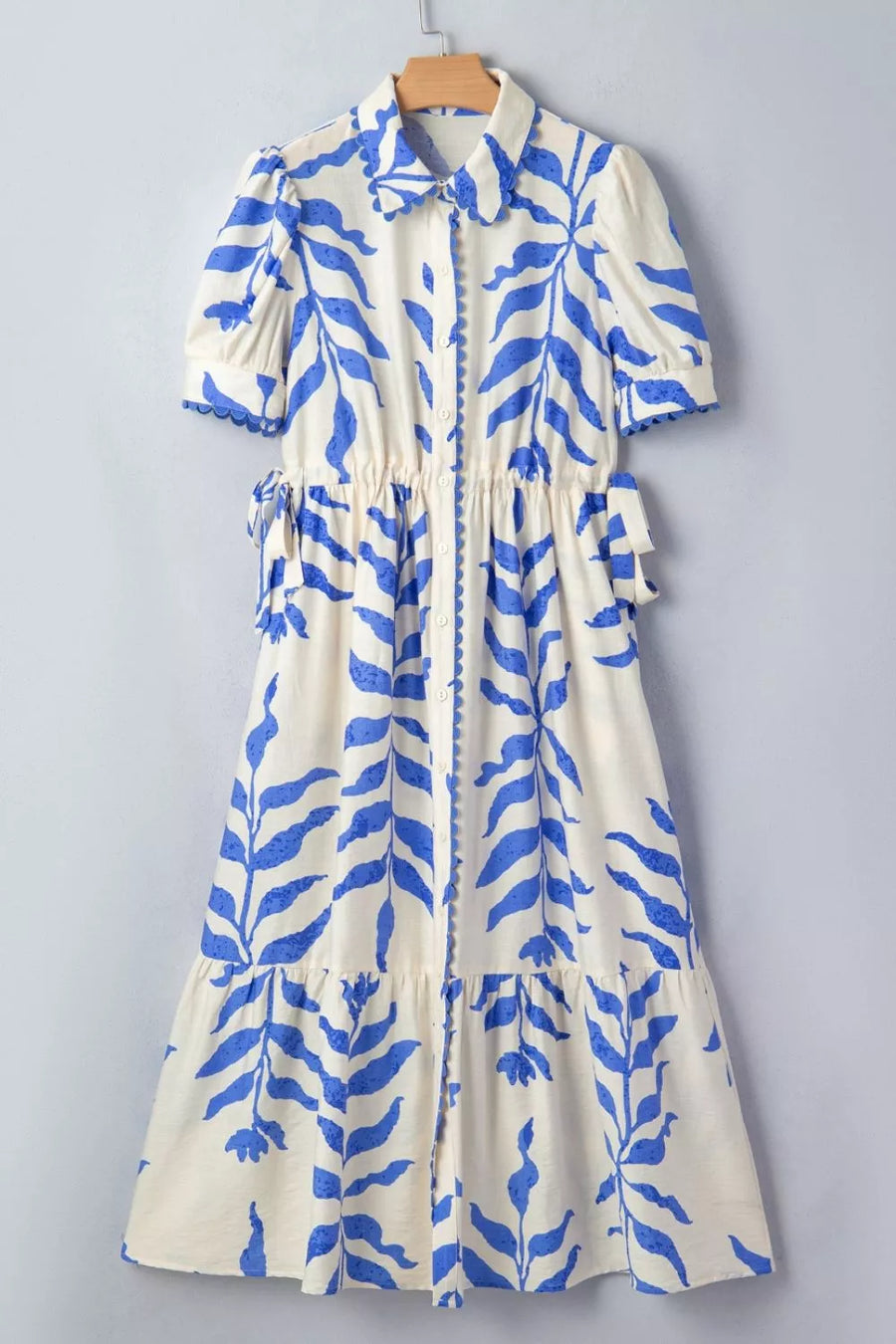 Maxi dress with botanical print, collared neckline, short sleeves, and side ties.