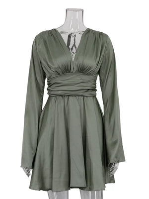 Sage green satin dress with V-neck, long sleeves, and cinched waist.