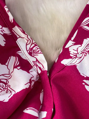 Rose red floral print romper with V-neck detail and wide legs.
