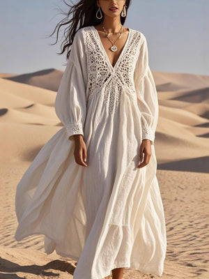 White crochet lace V-neck midi dress with long sleeves and cutout details.