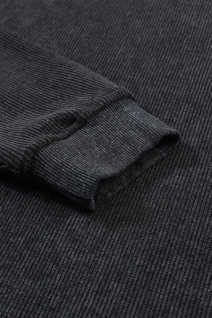 Black ribbed sweatshirt with textured fabric and cuffed sleeve detail