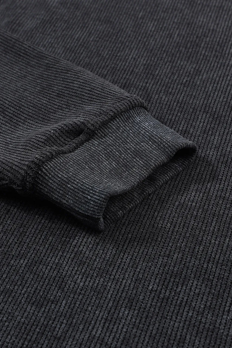 Black ribbed sweatshirt with textured fabric and cuffed sleeve detail