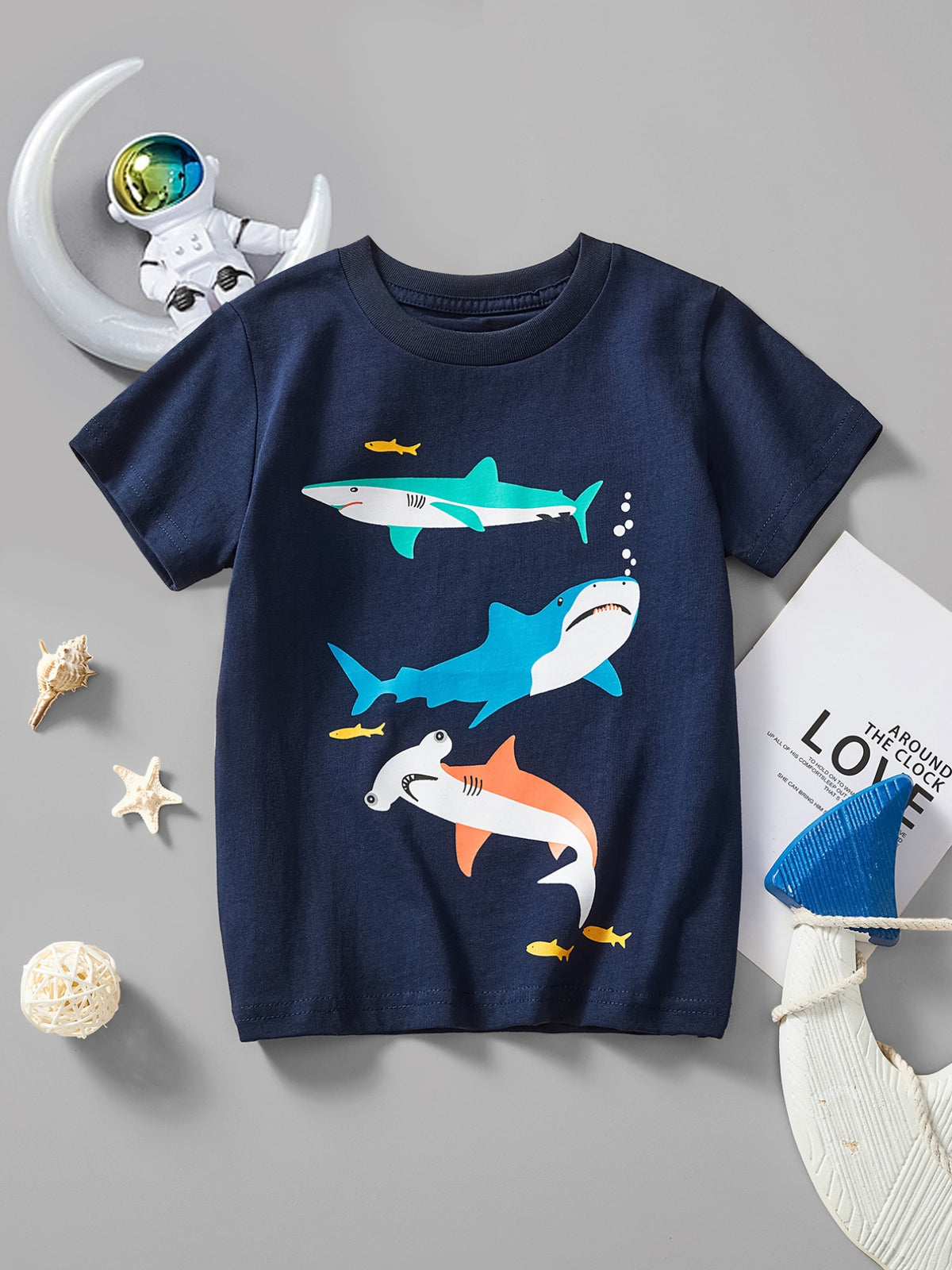 Navy cotton crew neck t-shirt with three colorful sharks and small yellow fish print.