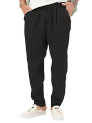 Black linen drawstring trousers with relaxed fit and adjustable waist.