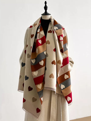 Cozy scarf with all-over heart print in beige, brown, gray, and red stripes.