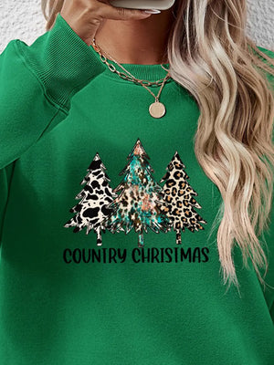 Green sweatshirt with country Christmas trees graphic and text.