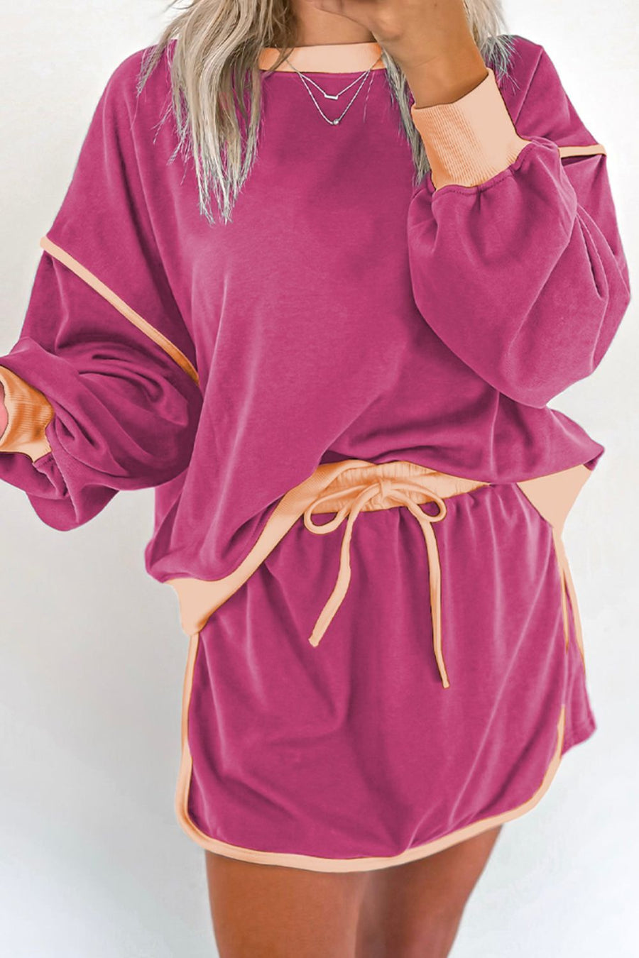 Contrast trim sweatshirt and skort set in Red-Violet with peach trim and drawstring waist.