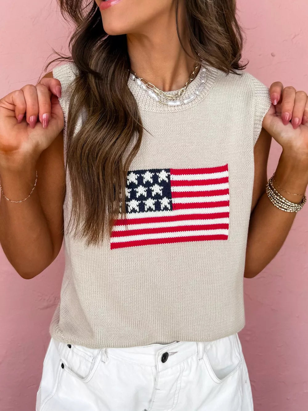 Beige knit sweater vest with American flag design, crew neck, sleeveless.