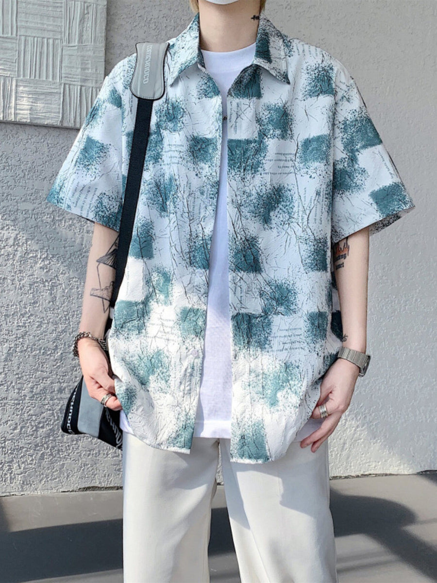 Men's abstract print short sleeve button-down shirt in white with teal accents.
