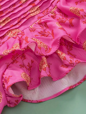 Pink floral print blouse with ruffled hem and pleated detail