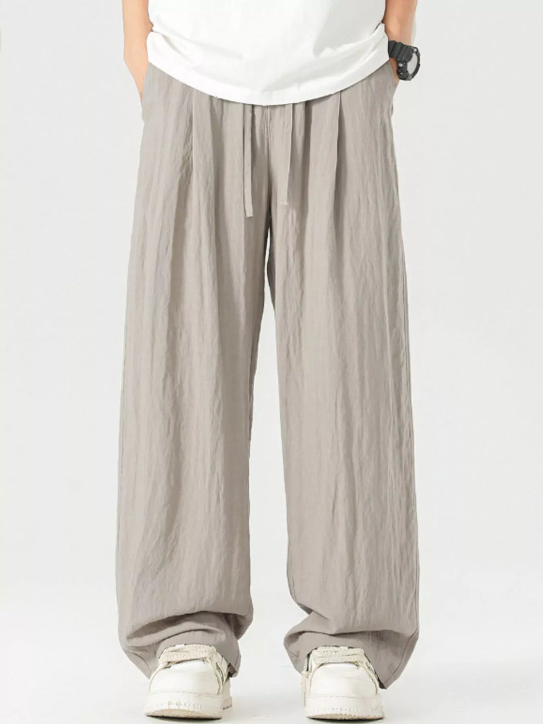 Lightweight wide-leg trousers in light gray with a drawstring waist and relaxed fit.