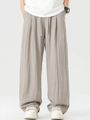 Lightweight wide-leg trousers in light gray with a drawstring waist and relaxed fit.