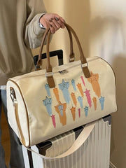 Off White canvas duffle bag with colorful star design and leather handles.