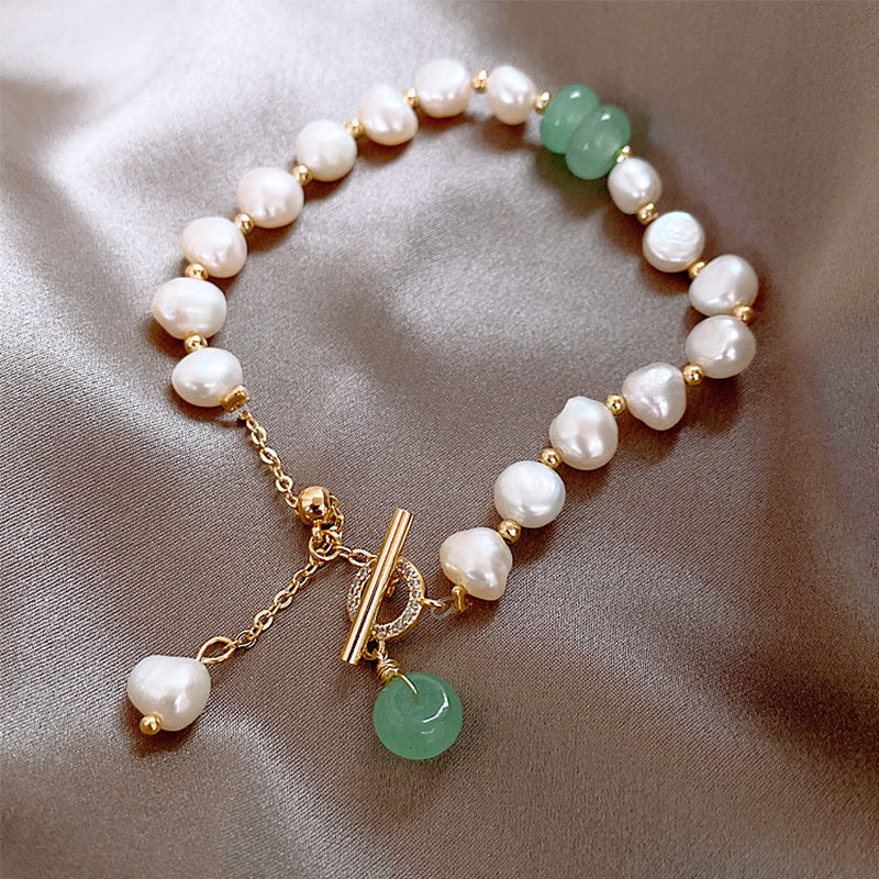 Pearl and green jade toggle bracelet with gold accents and a pearl dangle.