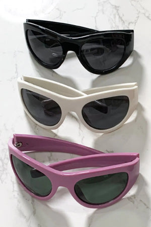 Sporty shield sunglasses in black, beige, and dusty pink with dark lenses.