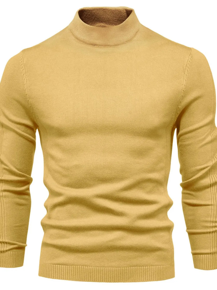 Gold ribbed mock neck sweater with sculpted shoulder detail and long sleeves.